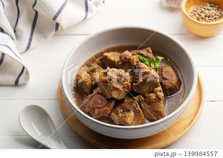 Braised pork spare ribs with soy sauce in white bowl. Braised pork spare ribs with soy sauce in white bowl. 139984557