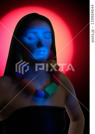 Woman meditating with closed eyes in ethereal light Woman meditating with closed eyes in ethereal light 139984644