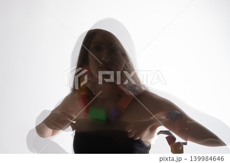 Woman with colorful necklace creating double exposure effect 139984646