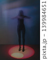 Woman silhouette dancing in abstract blurred movement and light 139984651
