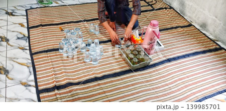 Serang, Banten, Indonesia, 05-27-2026, Arranging water glasses for guests 139985701