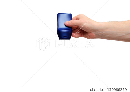 mans hand demonstrating a blue bottle of shampoo on a white background 139986259