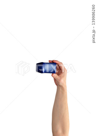 male hand raised up holding a blue bottle on a white background male hand raised up holding a blue bottle on a white background 139986260
