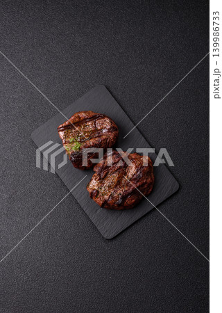 Beef mignon steak, rare, meat grilled with salt and spices. Beef steak Beef mignon steak, rare, meat grilled with salt and spices. Beef steak 139986733