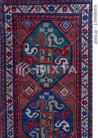 Authentic traditional Malibeyli carpet of the Karabakh type from Azerbaijan featuring intricate ornamental patterns, rich woven texture, and colorful Caucasian ethnic craftsmanship. Decorative 139986956