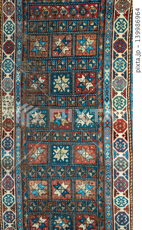 Authentic traditional Ganja carpet from Azerbaijan featuring detailed geometric ornaments, rich woven texture, and colorful ethnic Caucasian craftsmanship. Decorative oriental rug inspired by Authentic traditional Ganja carpet from Azerbaijan featuring detailed geometric ornaments, rich woven texture, and colorful ethnic Caucasian craftsmanship. Decorative oriental rug inspired by 139986964