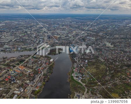 anoramic aerial view of Vinnytsia featuring the Southern Bug River, city bridge and central urban area. The image shows a wide cityscape with water, architecture and green urban surroundings 139987056