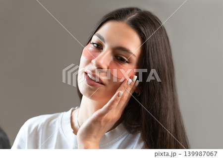 Young woman relaxing with hydrogel under-eye patches during daily skincare routine at home. Natural beauty portrait focused on self-care, healthy skin and modern cosmetic treatment. Young woman relaxing with hydrogel under-eye patches during daily skincare routine at home. Natural beauty portrait focused on self-care, healthy skin and modern cosmetic treatment. 139987067