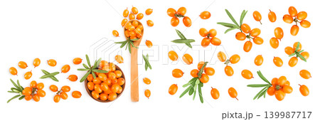 Sea buckthorn in wooden bowl. Fresh ripe berry with leaves isolated on white background with copy space for your text. Top view. Flat lay Sea buckthorn in wooden bowl. Fresh ripe berry with leaves isolated on white background with copy space for your text. Top view. Flat lay 139987717