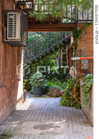 Narrow alleyway with brick buildings and cozy atmosphere, Tbilisi Narrow alleyway with brick buildings and cozy atmosphere, Tbilisi 139987998
