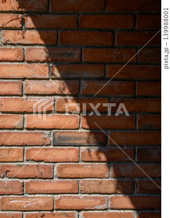 Old brick wall with diagonal sunlight and shadow Old brick wall with diagonal sunlight and shadow 139988001