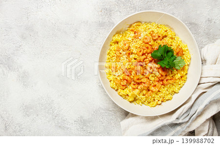 risotto with shrimp, in a bowl, on a textured surface, with a side dish of fresh coriander, homemade, no people, risotto with shrimp, in a bowl, on a textured surface, with a side dish of fresh coriander, homemade, no people, 139988702