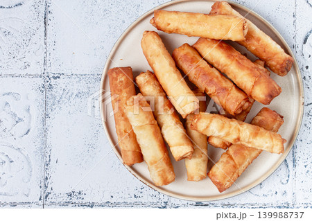 fried spring rolls with cheese, on a plate, with cream sauce, no people, fried spring rolls with cheese, on a plate, with cream sauce, no people, 139988737