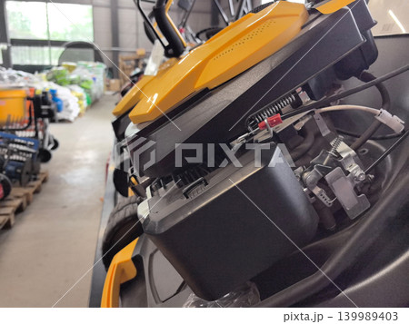 Exploring the inner workings of a modern lawnmower in a garden center Exploring the inner workings of a modern lawnmower in a garden center 139989403