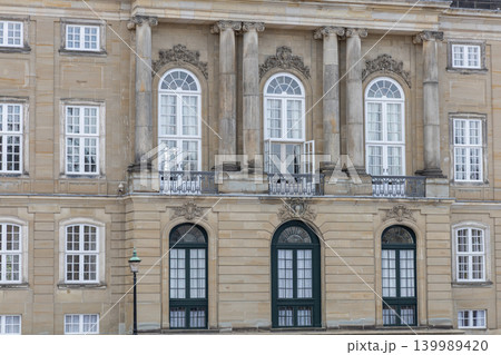 Exterior facade of Amalienborg Palace with Danish Royal Flag in Copenhagen, Denmark. Exterior facade of Amalienborg Palace with Danish Royal Flag in Copenhagen, Denmark. 139989420