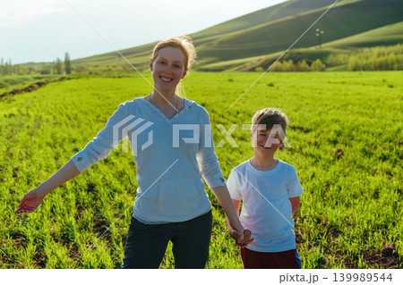 Happy mother and son portrait in the field on a sunny day 139989544