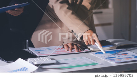 Accountants processing financial documents and taxes, managing corporate finance in a modern office. Audit and taxes in business Accountants processing financial documents and taxes, managing corporate finance in a modern office. Audit and taxes in business 139989702
