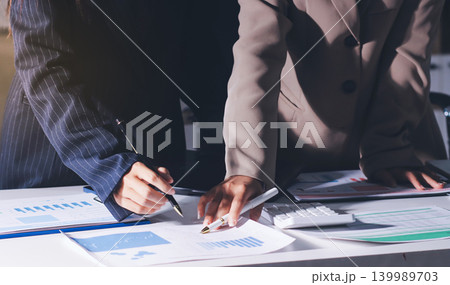 Accountants processing financial documents and taxes, managing corporate finance in a modern office. Audit and taxes in business Accountants processing financial documents and taxes, managing corporate finance in a modern office. Audit and taxes in business 139989703