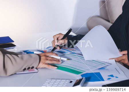 Accountants processing financial documents and taxes, managing corporate finance in a modern office. Audit and taxes in business 139989714