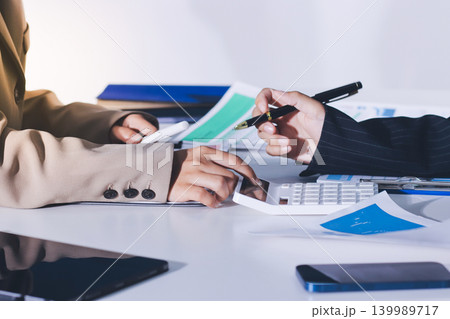 Accountants processing financial documents and taxes, managing corporate finance in a modern office. Audit and taxes in business 139989717