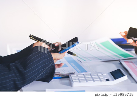 Accountants processing financial documents and taxes, managing corporate finance in a modern office. Audit and taxes in business Accountants processing financial documents and taxes, managing corporate finance in a modern office. Audit and taxes in business 139989719
