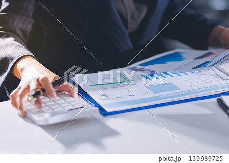 Accountants processing financial documents and taxes, managing corporate finance in a modern office. Audit and taxes in business Accountants processing financial documents and taxes, managing corporate finance in a modern office. Audit and taxes in business 139989725