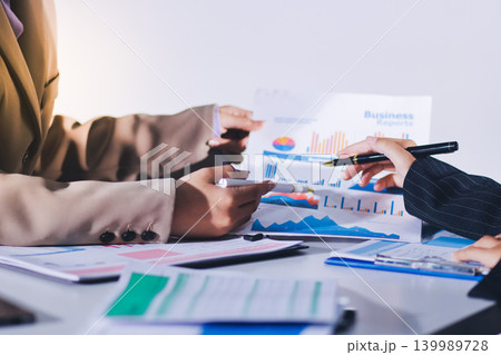 Accountants processing financial documents and taxes, managing corporate finance in a modern office. Audit and taxes in business 139989728
