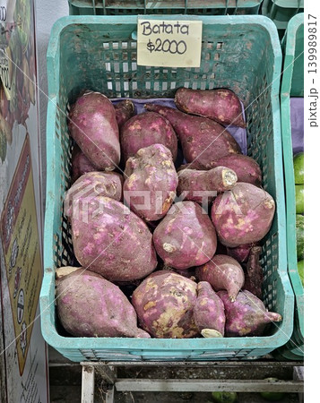 Cordoba, Argentina - April 9, 2026: purple sweet potatoes in market crate Cordoba, Argentina - April 9, 2026: purple sweet potatoes in market crate 139989817