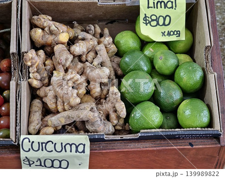 Cordoba, Argentina - April 9, 2026: turmeric and limes displayed in cardboard produce boxes Cordoba, Argentina - April 9, 2026: turmeric and limes displayed in cardboard produce boxes 139989822