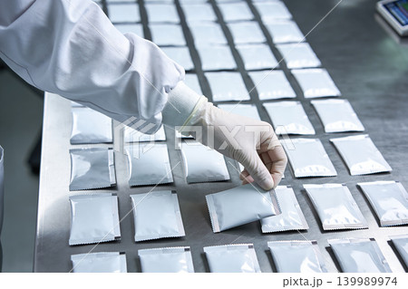 Hand inspecting packaged samples in a sterile laboratory environment 139989974