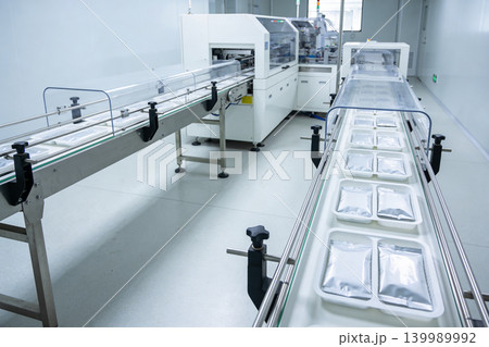 Automated packaging line in a modern food production facility with conveyor belts Automated packaging line in a modern food production facility with conveyor belts 139989992