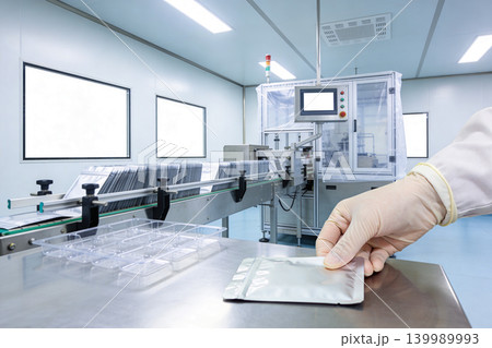 Modern pharmaceutical production line in a cleanroom environment Modern pharmaceutical production line in a cleanroom environment 139989993