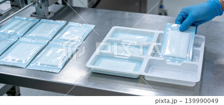 Sterile medical supplies being packaged and organized in a clean room environment Sterile medical supplies being packaged and organized in a clean room environment 139990049