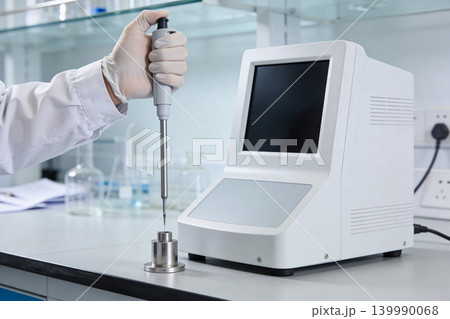 Scientist uses pipette and advanced laboratory equipment for precise measurement Scientist uses pipette and advanced laboratory equipment for precise measurement 139990068