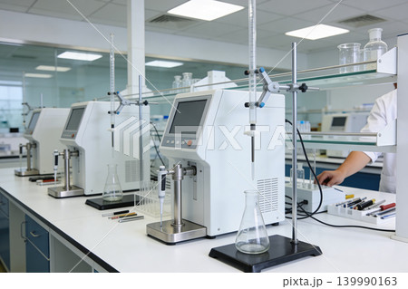 Modern laboratory equipment with automated titrators and glassware for scientific research Modern laboratory equipment with automated titrators and glassware for scientific research 139990163