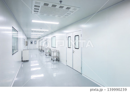 Cleanroom monitoring device in sterile hallway with carts and observation windows Cleanroom monitoring device in sterile hallway with carts and observation windows 139990239