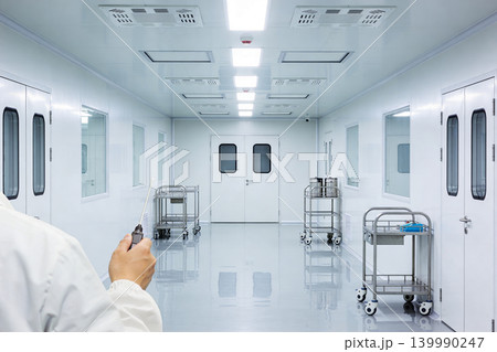 Scientist in cleanroom holding probe for environmental monitoring 139990247