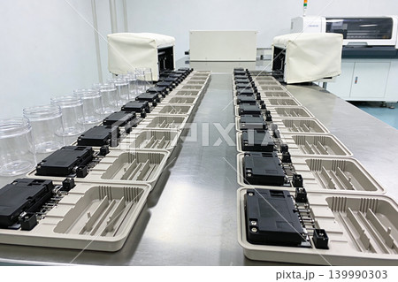 Automated assembly line with electronic components and jars in a cleanroom environment Automated assembly line with electronic components and jars in a cleanroom environment 139990303