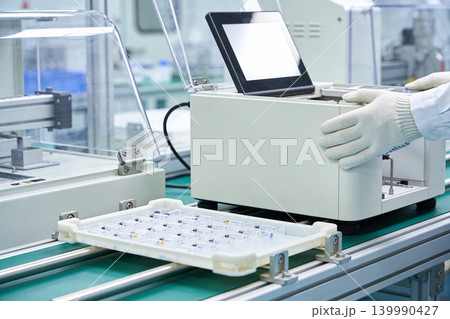 Automated pharmaceutical production line with vials and advanced machinery Automated pharmaceutical production line with vials and advanced machinery 139990427