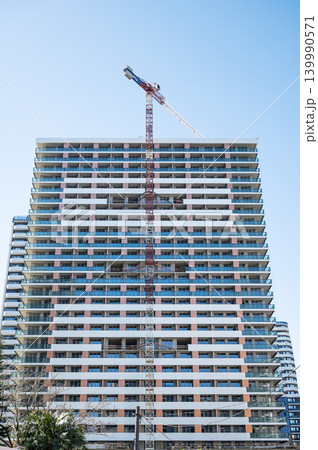 High-rise building under construction with tower crane, urban development and real estate concept High-rise building under construction with tower crane, urban development and real estate concept 139990571