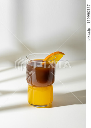 Cold bumble coffee with orange juice and ice on light background Cold bumble coffee with orange juice and ice on light background 139990587