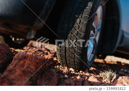 Car wheel standing on stones close-up view 139991822