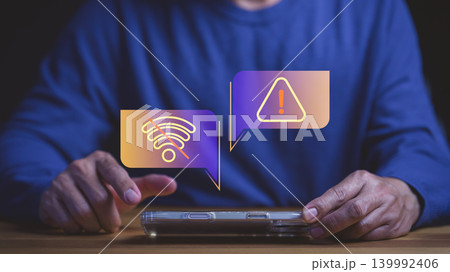 Man holding smartphone with no wifi signal and warning icon for internet connection problem, technology error, and disconnected network issues alert. Man holding smartphone with no wifi signal and warning icon for internet connection problem, technology error, and disconnected network issues alert. 139992406