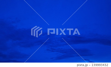 Deep Blue Cloudy Sky Background with Dramatic Atmospheric Evening Nature Scene Deep Blue Cloudy Sky Background with Dramatic Atmospheric Evening Nature Scene 139993432