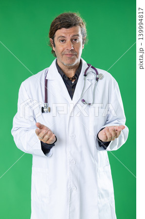 Adult male medic talking on mobile phone on green screen Adult male medic talking on mobile phone on green screen 139994817