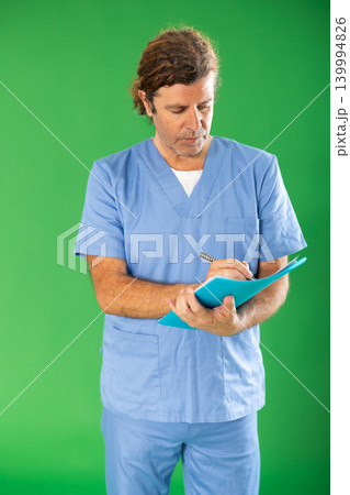 nurse makes notes in a document against the background of chromakey 139994826