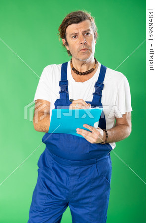 employee holds a folder with documents in hands against the background of chromakey 139994831
