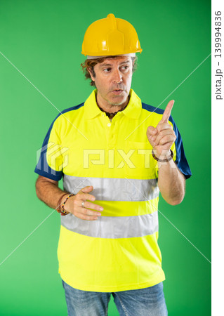 worker in reflective clothing tells the basic rules against the background of chromakey worker in reflective clothing tells the basic rules against the background of chromakey 139994836