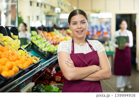 Middle-aged woman seller stands with arms crossed on chest and waits for customers Middle-aged woman seller stands with arms crossed on chest and waits for customers 139994916
