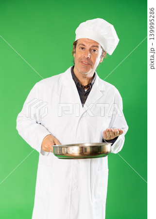 Man cook with frying pan address appeal to imaginary interlocutor, explain technology. Man cook with frying pan address appeal to imaginary interlocutor, explain technology. 139995286